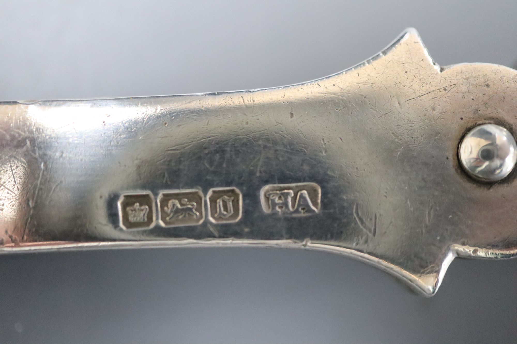 A collection of small silver to include a cased set of six coffee spoons and tongs, three wine labels and a pair of grape scissors